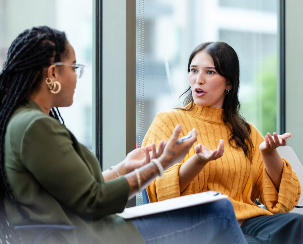 A woman talks expressively during a private counseling session.