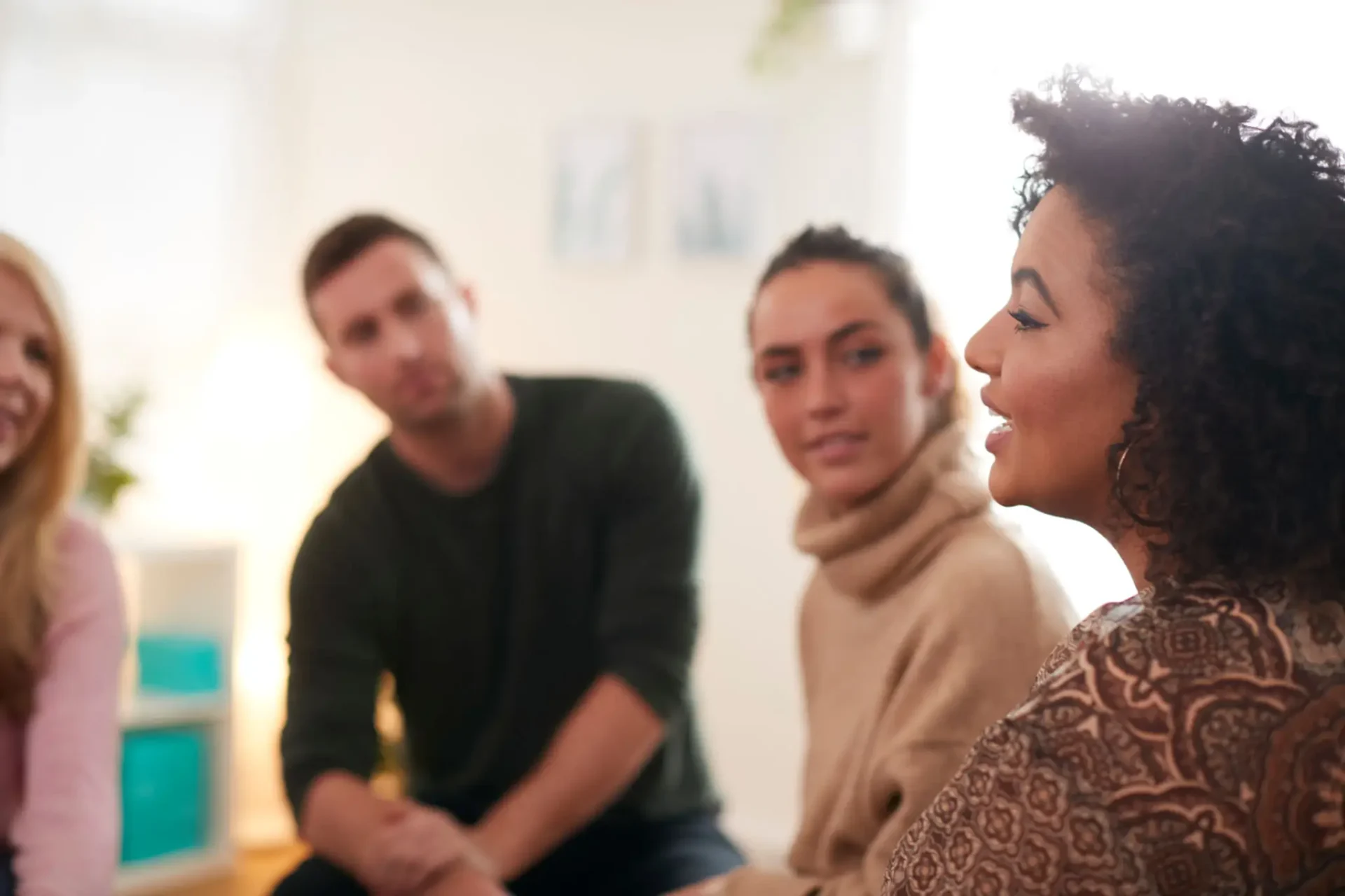 Four people in the middle of a therapy session.